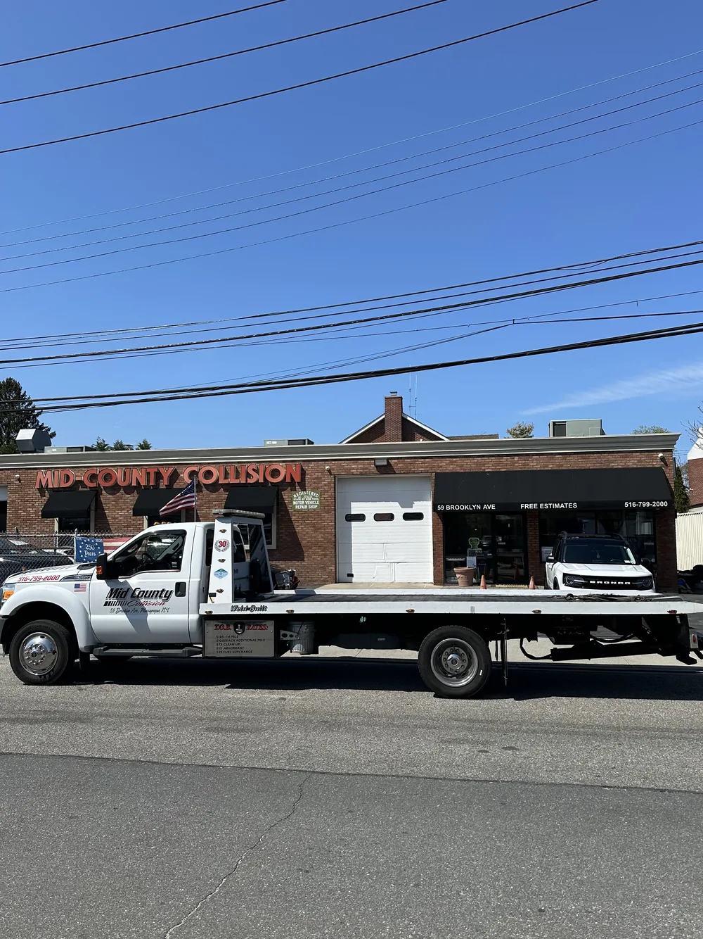 24-hour flatbed towing by Mid-County Collision in Massapequa NY